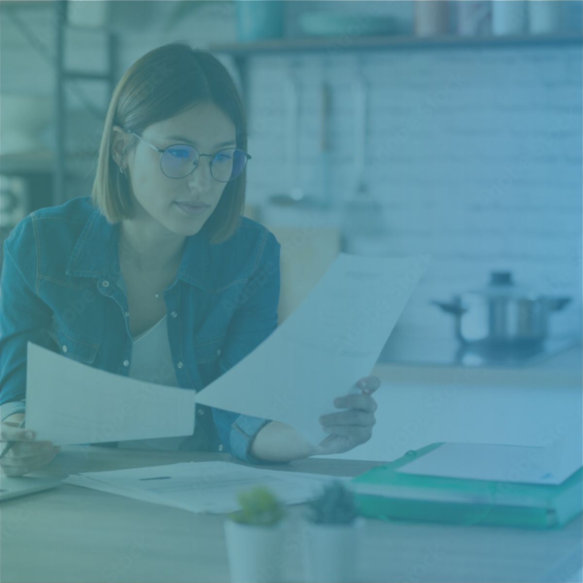 A recruitment agency director reviewing client invoices to understand invoice finance and funding solutions.