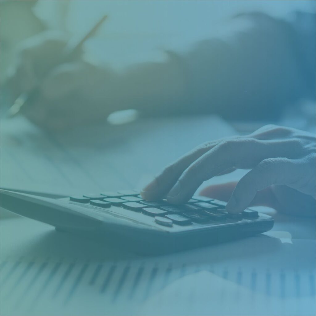 A professional using a calculator to figure out cost considerations for outsourcing recruitment back-office and accounts.